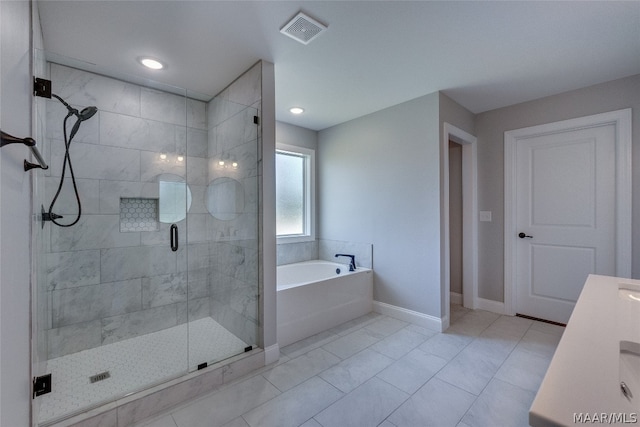 bathroom featuring vanity and independent shower and bath