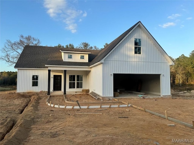 modern farmhouse with a garage and covered porch