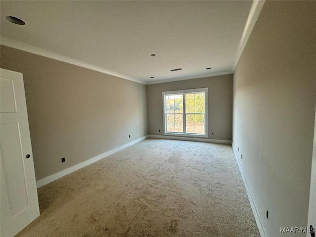 carpeted empty room featuring crown molding