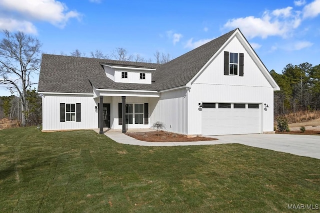 modern inspired farmhouse featuring a garage, a front lawn, and covered porch