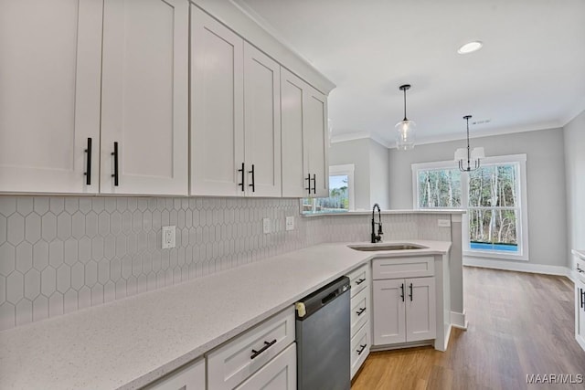 kitchen featuring sink, white cabinetry, crown molding, decorative light fixtures, and stainless steel dishwasher