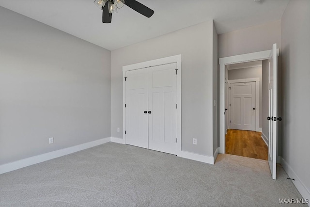 unfurnished bedroom featuring carpet, ceiling fan, and a closet