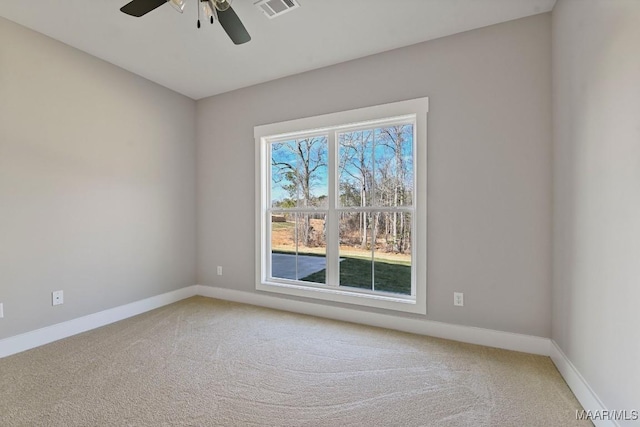 carpeted spare room featuring ceiling fan