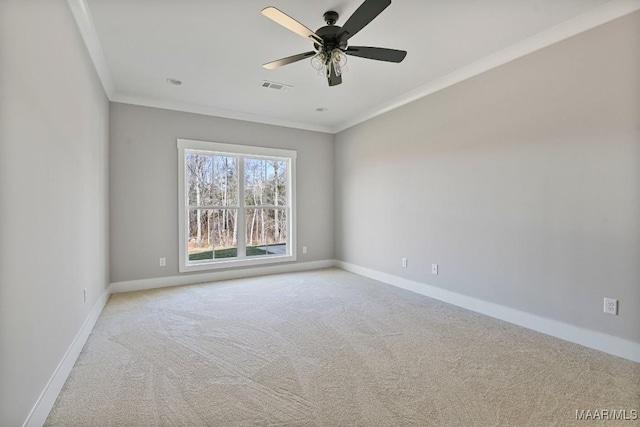 carpeted empty room featuring ornamental molding and ceiling fan