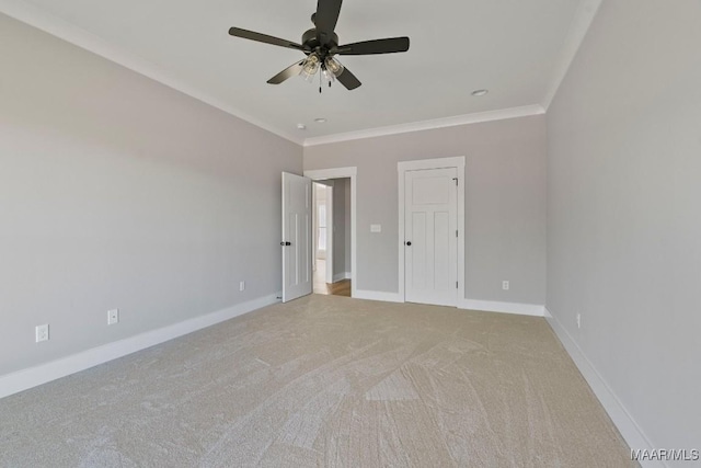 carpeted spare room featuring ornamental molding and ceiling fan