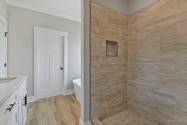 bathroom with vanity, shower with separate bathtub, and hardwood / wood-style floors