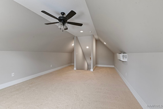 additional living space featuring ceiling fan, light colored carpet, and vaulted ceiling