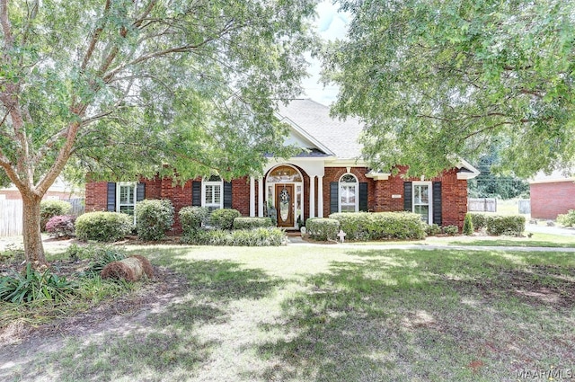 obstructed view of property featuring a front yard