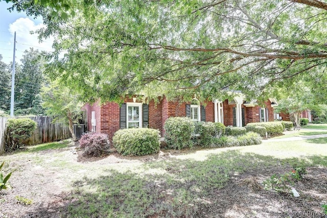 view of side of home with central AC and a yard