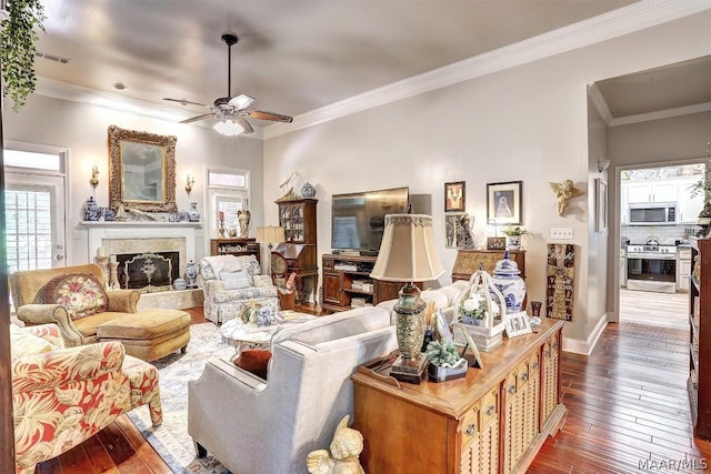 living room featuring ceiling fan, dark hardwood / wood-style floors, and ornamental molding