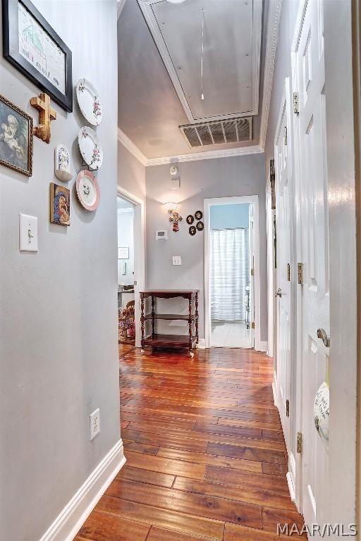 hall with dark hardwood / wood-style floors and crown molding