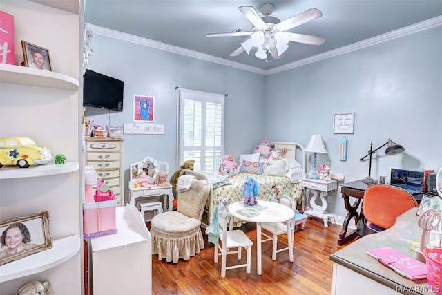 bedroom featuring ceiling fan, ornamental molding, and hardwood / wood-style flooring