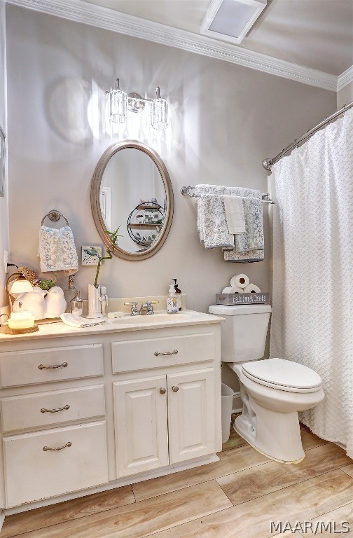 bathroom featuring hardwood / wood-style floors, vanity, crown molding, a shower with shower curtain, and toilet