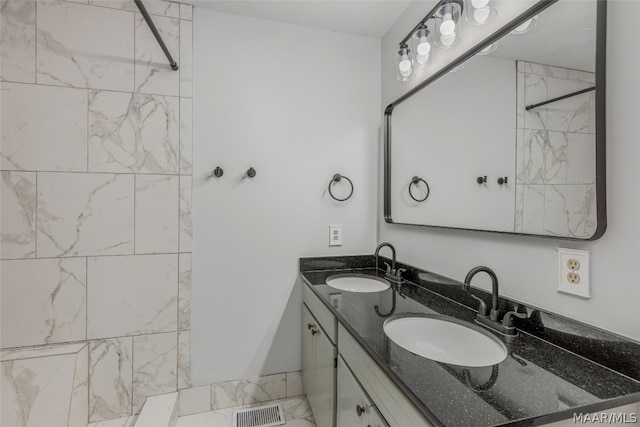 bathroom featuring vanity and a tile shower