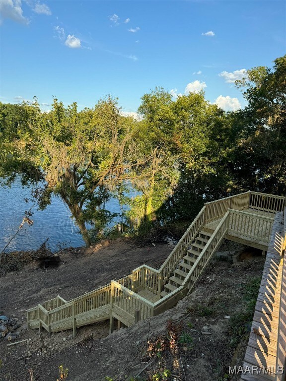 exterior space with a deck with water view