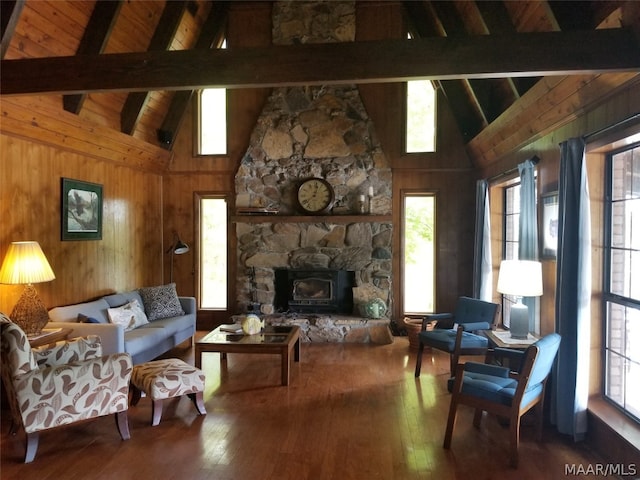 living room featuring wood ceiling, hardwood / wood-style flooring, beam ceiling, and a wood stove