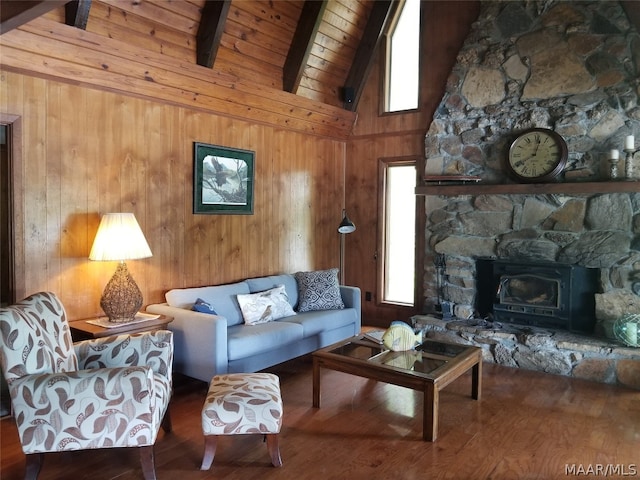 living room with hardwood / wood-style flooring, wood ceiling, a wood stove, high vaulted ceiling, and beam ceiling