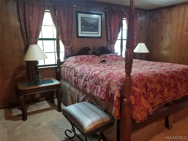 carpeted bedroom with wood walls and multiple windows