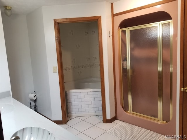 bathroom with tile patterned flooring, independent shower and bath, and vanity