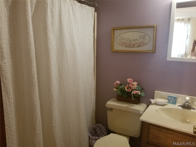 bathroom featuring toilet and vanity