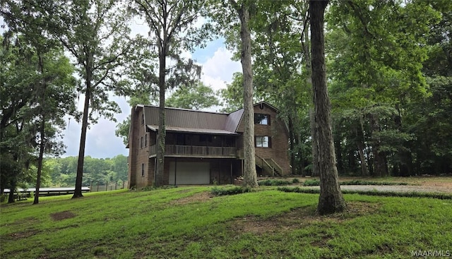 back of property featuring a garage and a yard