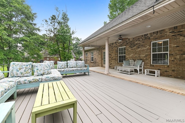 wooden terrace with outdoor lounge area and ceiling fan