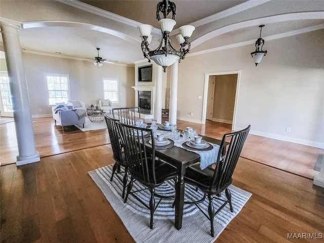 dining room featuring ornamental molding, ceiling fan with notable chandelier, and hardwood / wood-style flooring