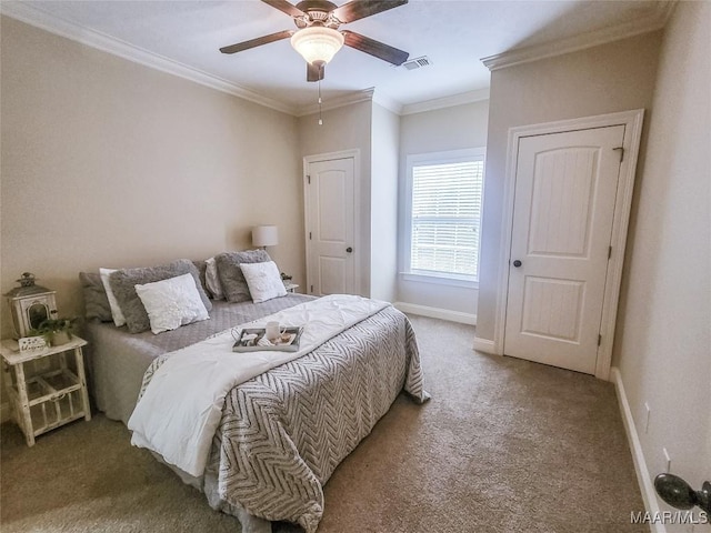 carpeted bedroom featuring ceiling fan and crown molding