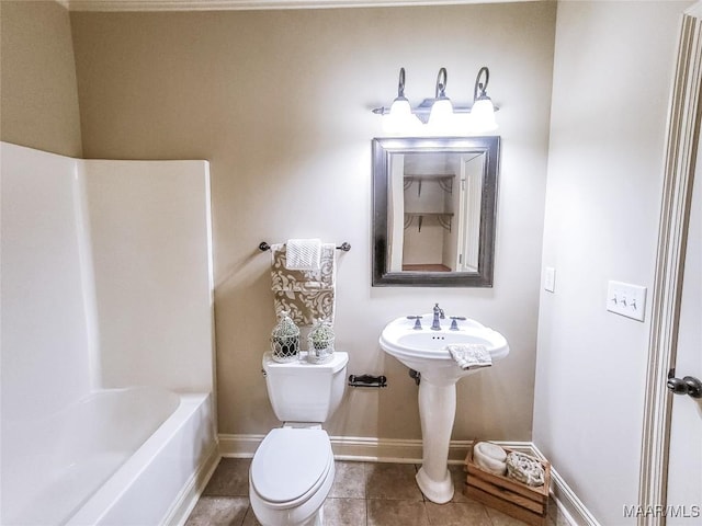 bathroom with tile patterned flooring, shower / bathing tub combination, and toilet