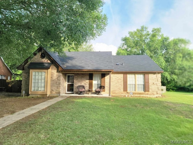 view of front of home with a front yard and a patio