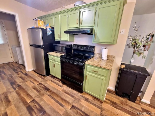 kitchen with green cabinets, appliances with stainless steel finishes, light hardwood / wood-style flooring, and light stone counters