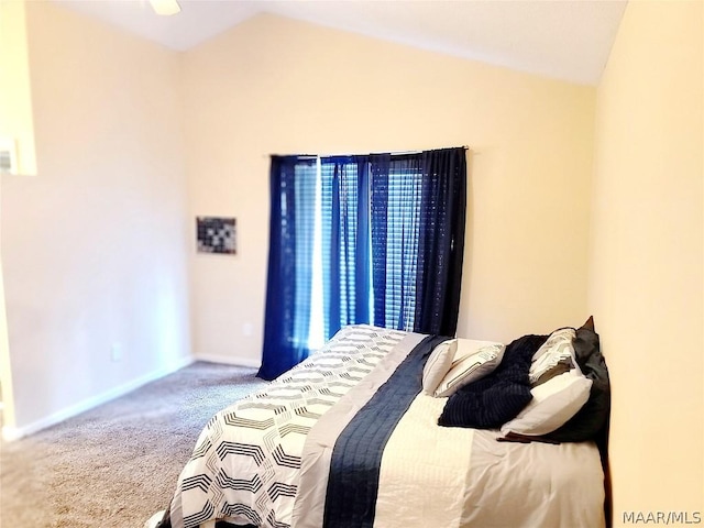 bedroom featuring lofted ceiling and carpet floors