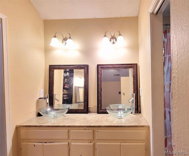 bathroom with vanity and a textured ceiling