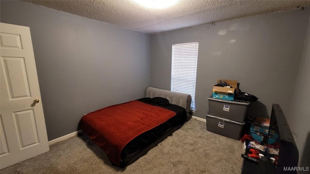 carpeted bedroom featuring a textured ceiling