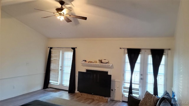 unfurnished living room with ceiling fan, wood-type flooring, french doors, and vaulted ceiling