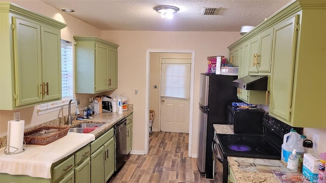 kitchen featuring black appliances, sink, and green cabinetry