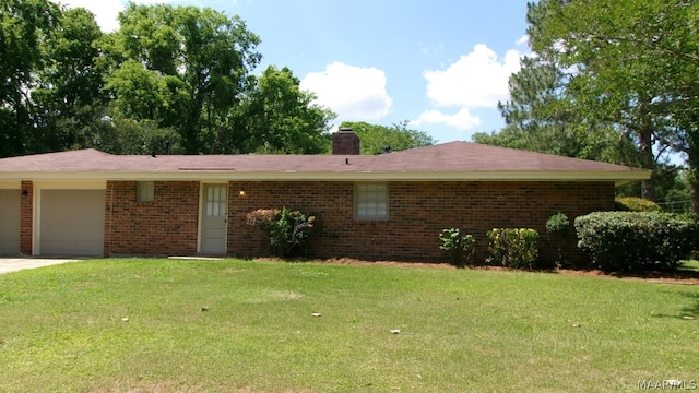 ranch-style house with a garage and a front lawn