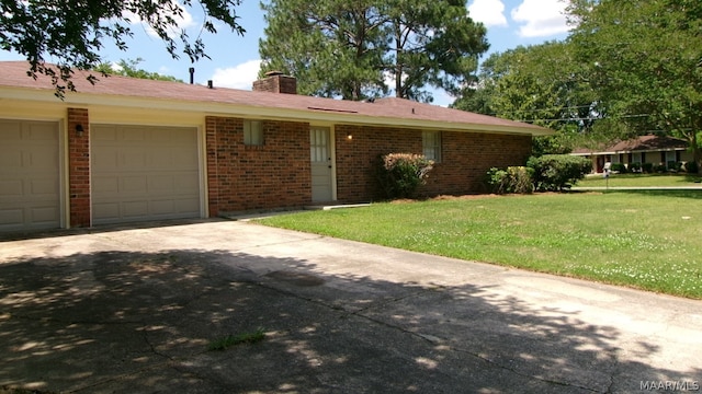 ranch-style house with a front yard and a garage