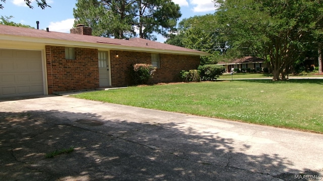 exterior space with a garage and a front lawn