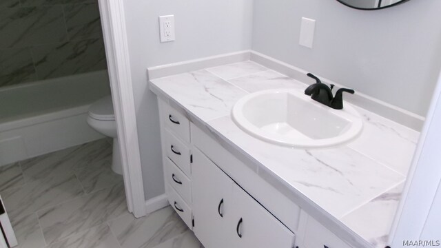 bathroom featuring tile floors, vanity, and toilet