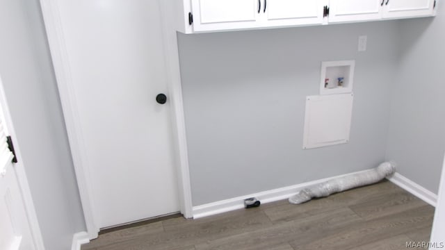 washroom featuring washer hookup, cabinets, and wood-type flooring