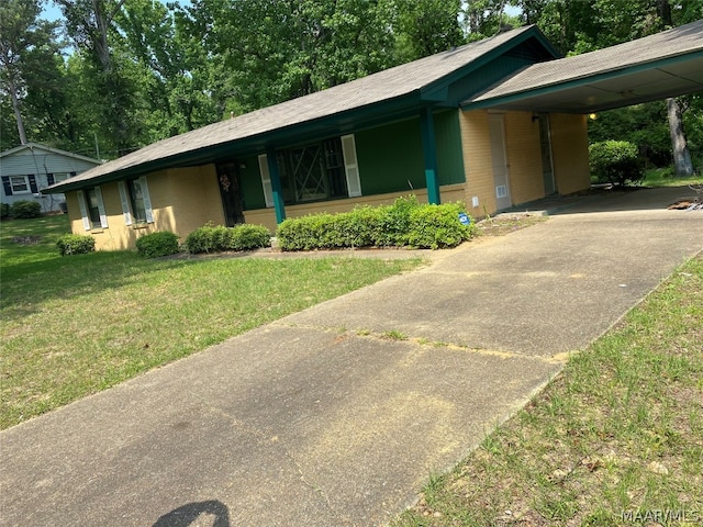 ranch-style home featuring a front yard and a carport