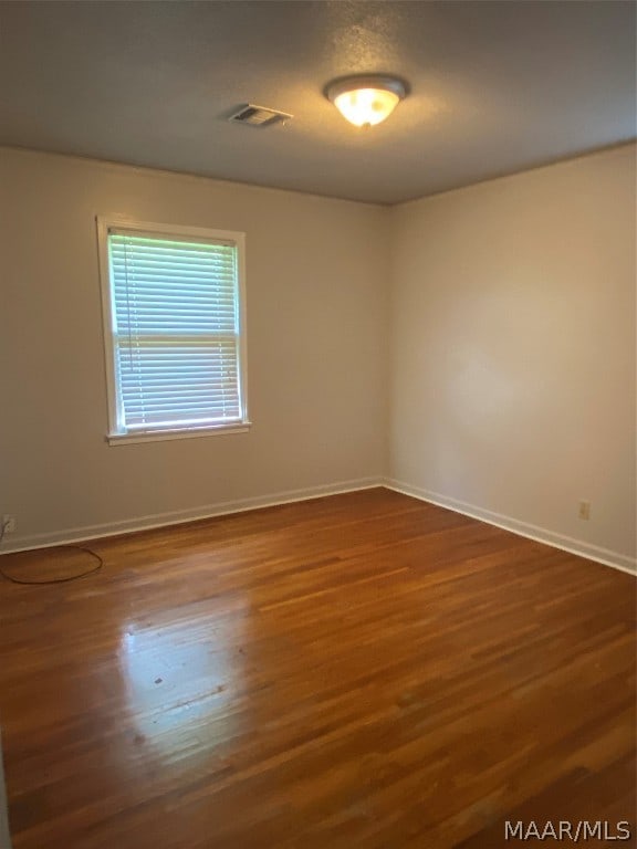 empty room featuring hardwood / wood-style flooring