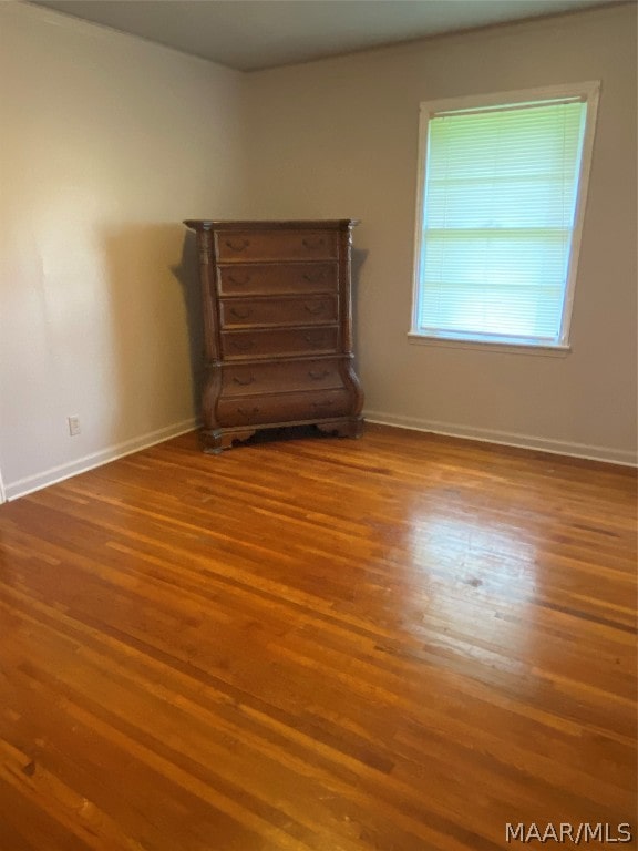 unfurnished room with hardwood / wood-style floors