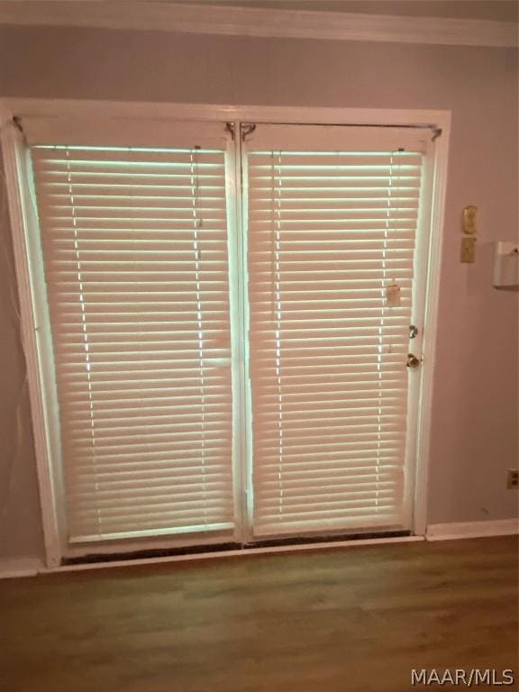 interior details with crown molding and hardwood / wood-style flooring