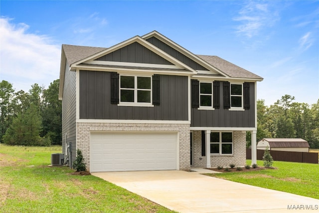 craftsman-style home with central AC unit, a garage, and a front yard