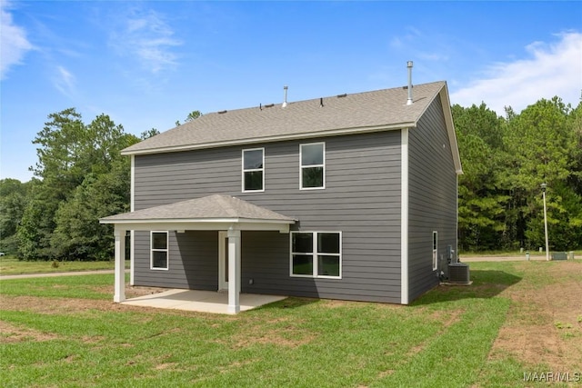 back of house featuring a lawn, cooling unit, and a patio area