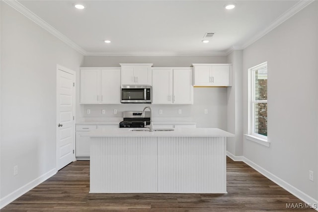 kitchen with a kitchen island with sink, white cabinets, stainless steel appliances, and dark hardwood / wood-style floors