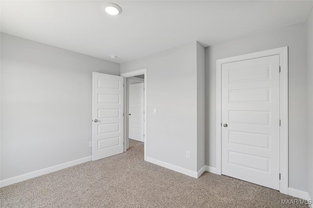 unfurnished bedroom with carpet floors and a closet