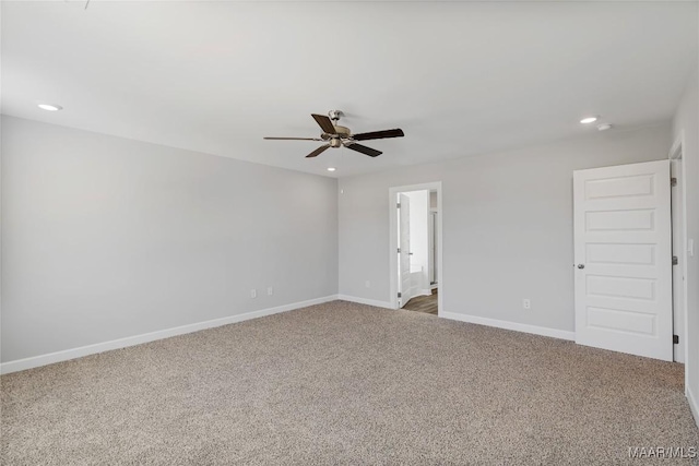 spare room with ceiling fan and carpet